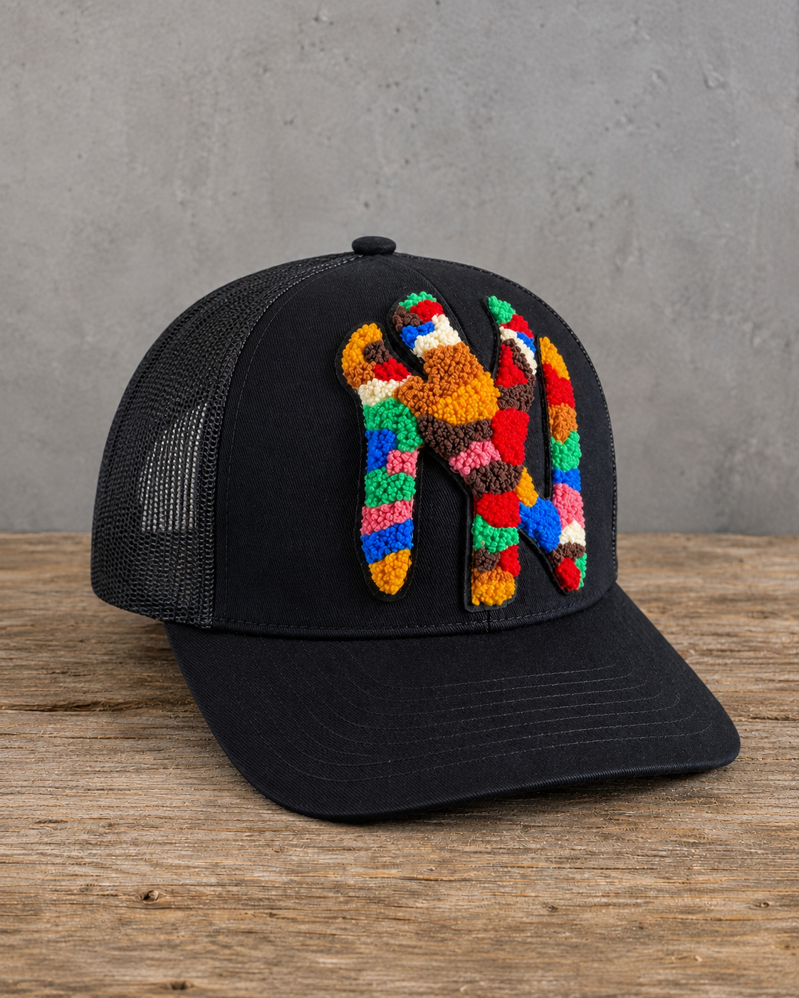 left view The Onyx Collection Statement NY Chenille Hat with oversized multicolor chenille NY patch on black cap