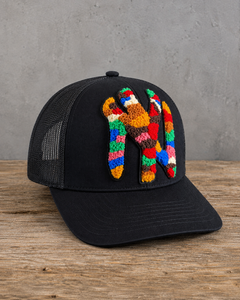 left view The Onyx Collection Statement NY Chenille Hat with oversized multicolor chenille NY patch on black cap