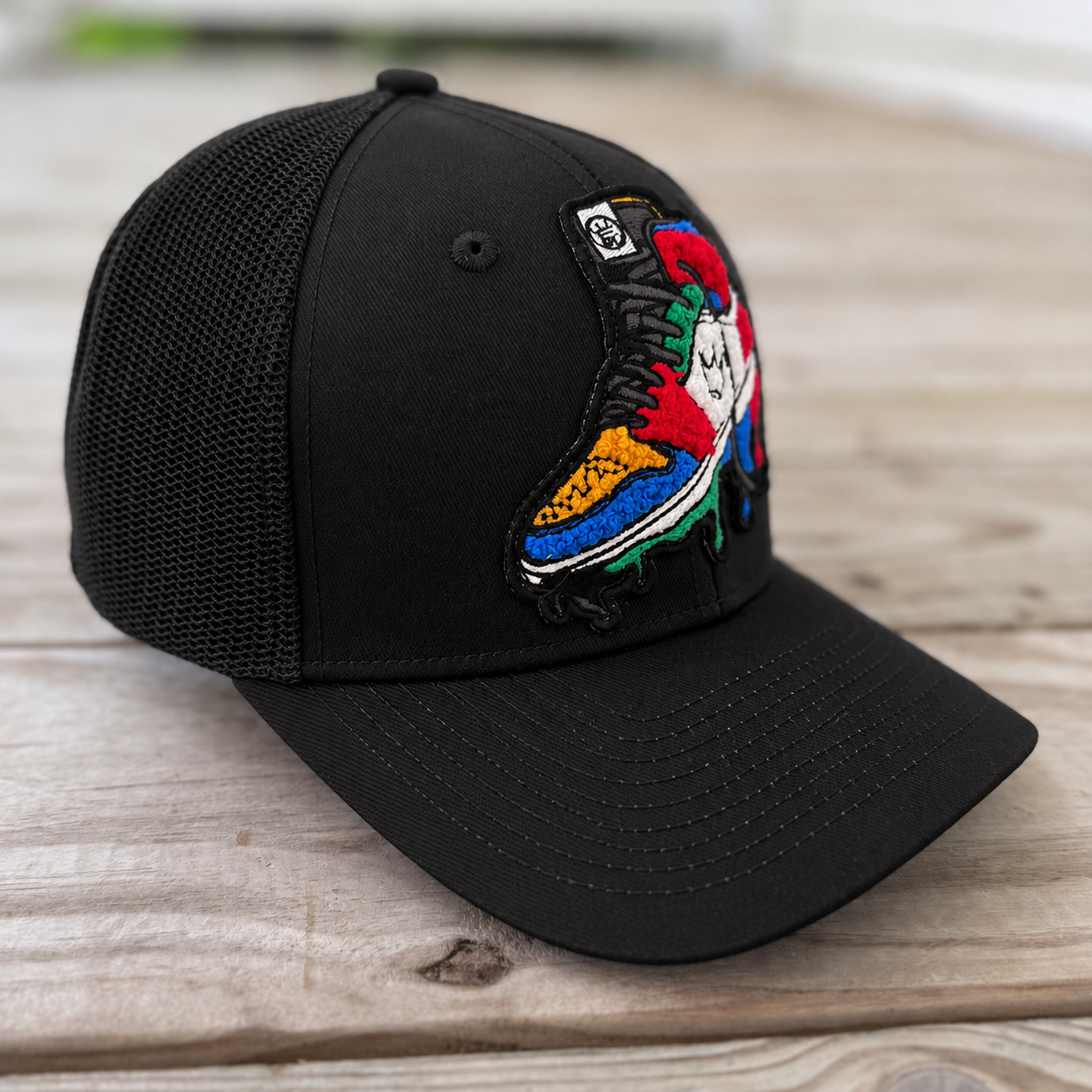 side view The Onyx Collection Chenille Rebel Sneaker black hat with handcrafted patchwork