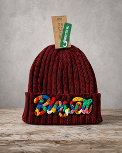 Burgundy sustainable cable knit beanie featuring a handcrafted chenille Blessed patch