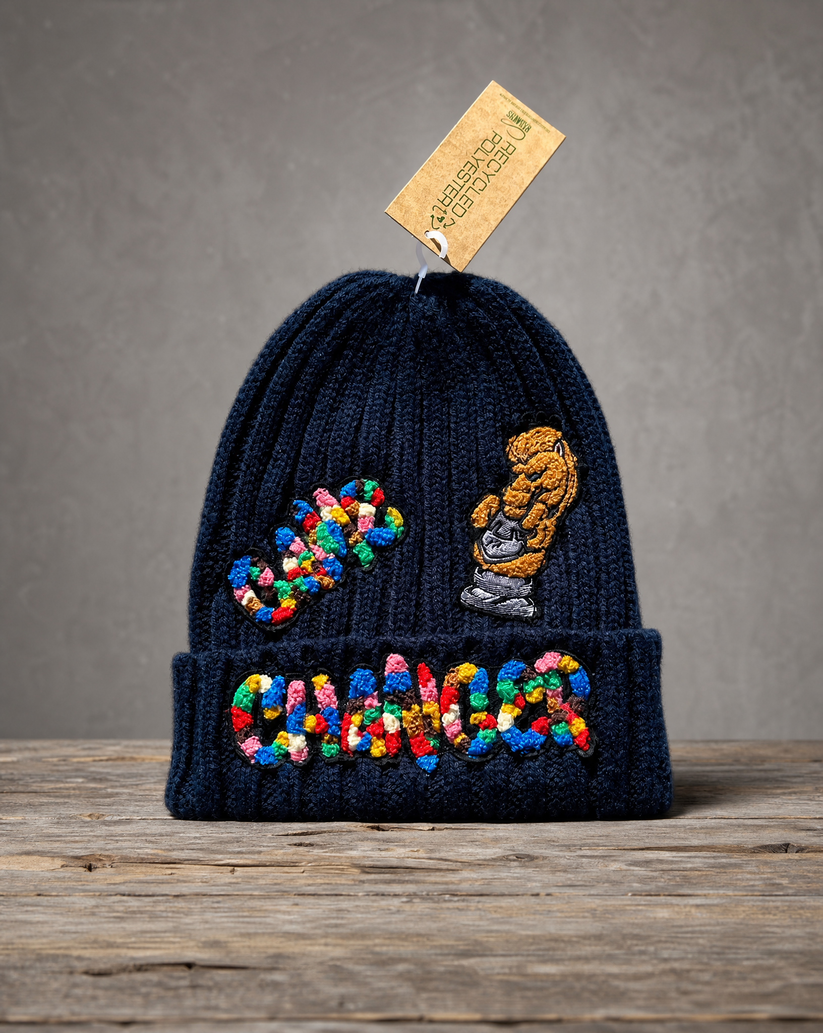 Sustainable cable knit beanie featuring a handcrafted Game Changer patch