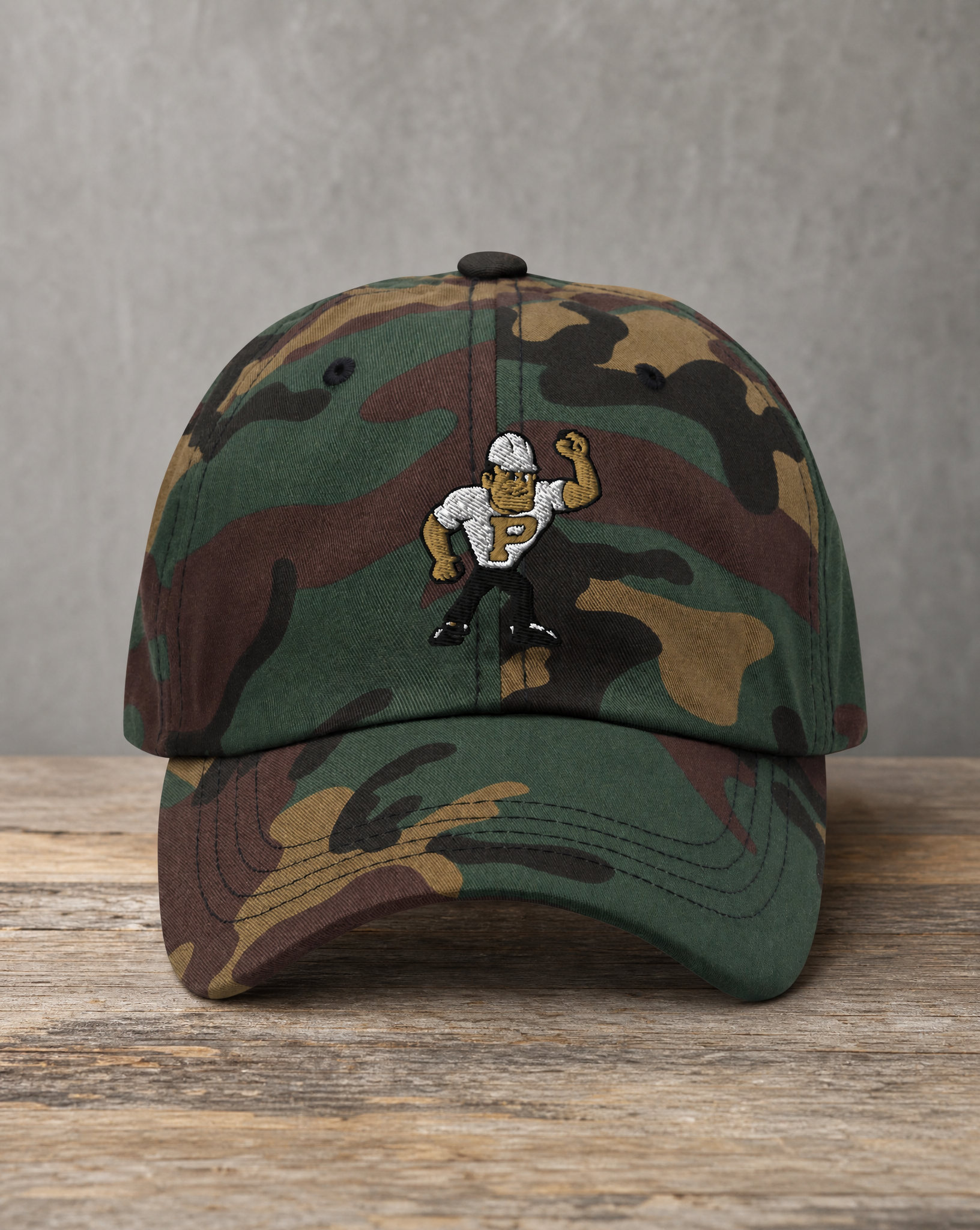 Hand-drawn Purdue mascot patch on a woodland camo hat, handcrafted City Collection by Believe In New York
