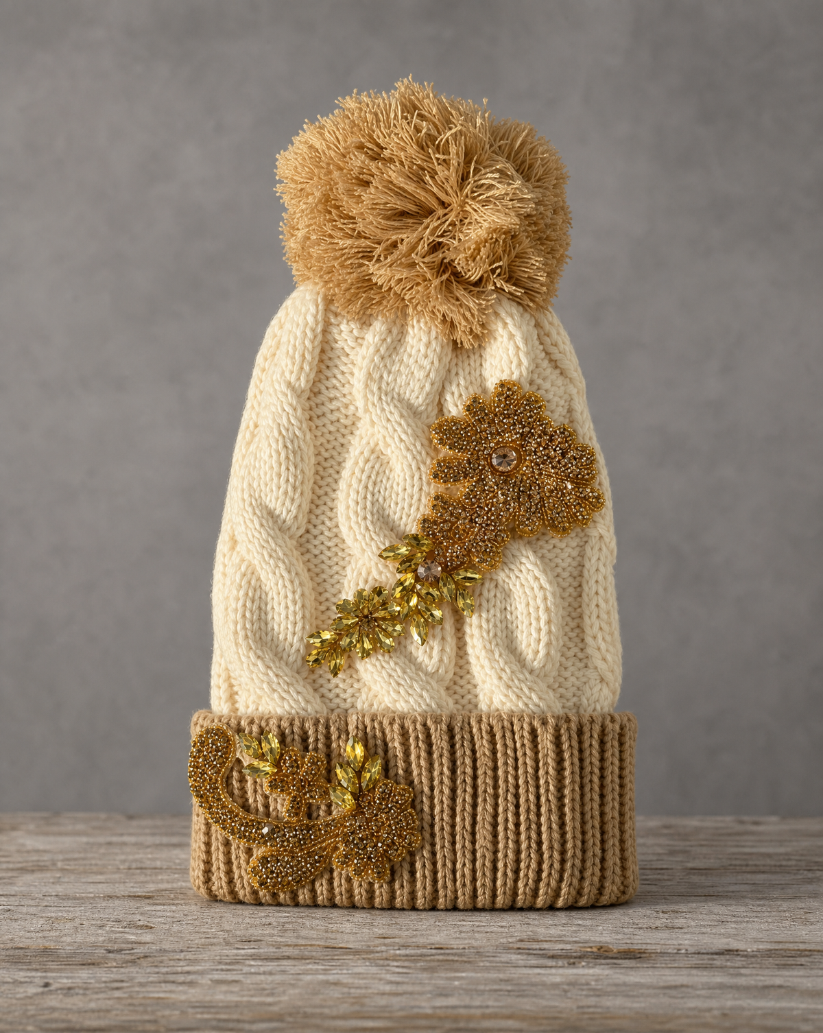 Gold crystal appliqué cable knit pom beanie with handcrafted crystal embellishments