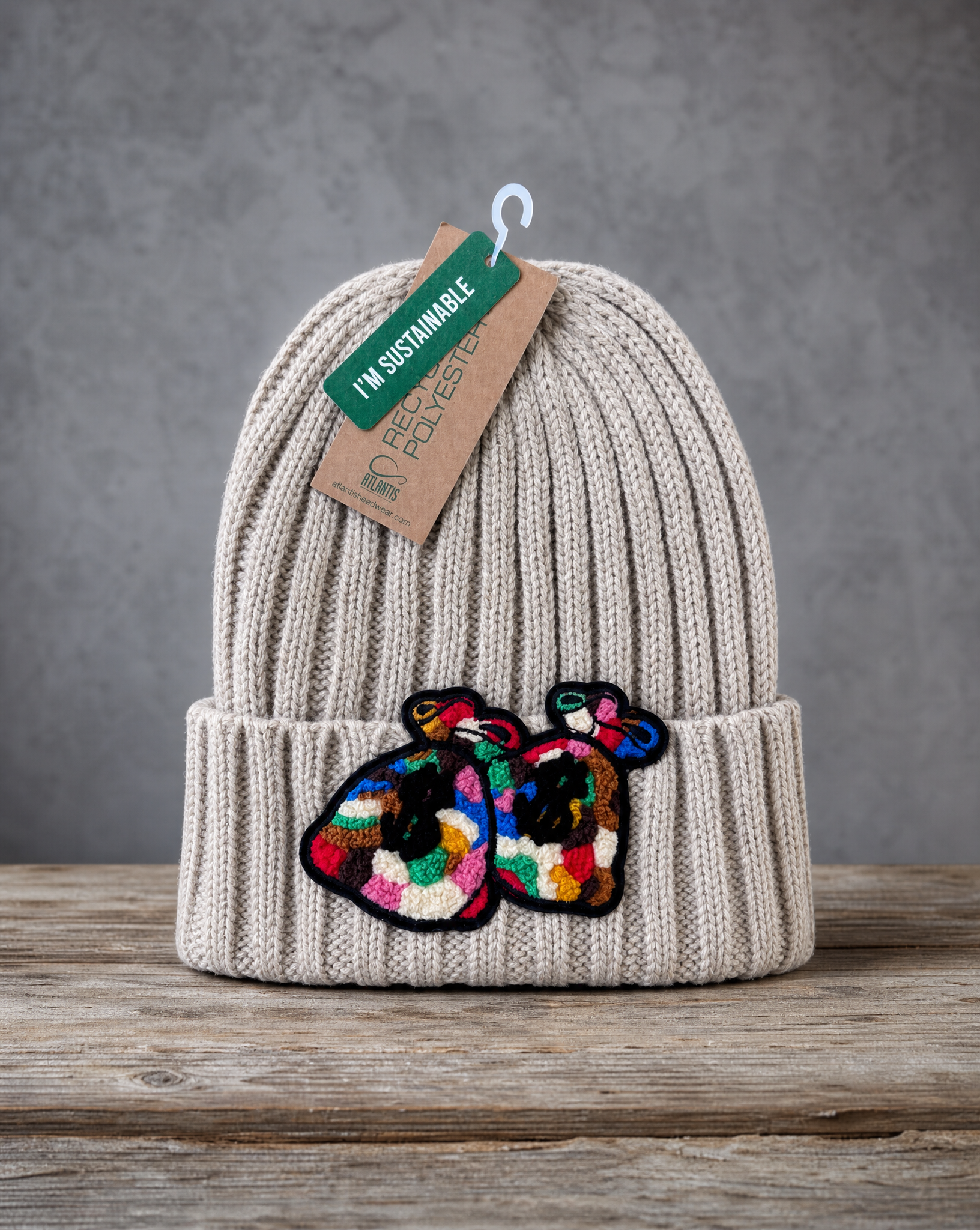 Beige cable knit beanie featuring a handcrafted chenille Money Bag patch