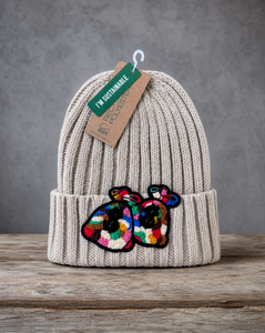 Beige cable knit beanie featuring a handcrafted chenille Money Bag patch