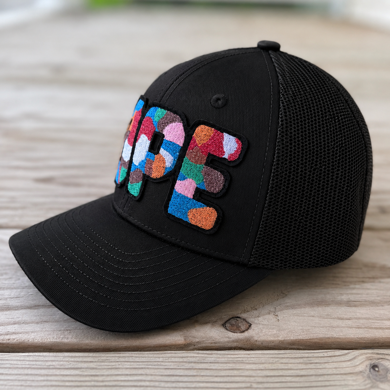 side view The Onyx Collection Glow in the Dark DOPE black hat with bold handcrafted lettering