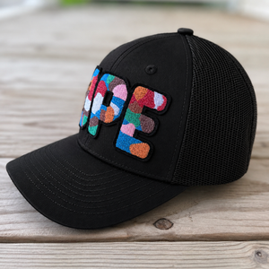 side view The Onyx Collection Glow in the Dark DOPE black hat with bold handcrafted lettering