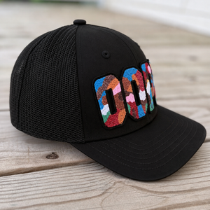 side view The Onyx Collection Glow in the Dark DOPE black hat with bold handcrafted lettering