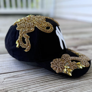 Right-side view of Gold Crystal Appliqué Black New York Hat with hand-applied gold crystals