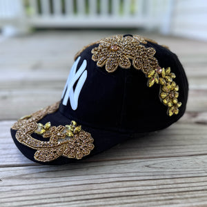 Left-side view of Gold Crystal Appliqué Black New York Hat with hand-applied gold crystals
