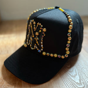 side view Black and gold pearl crystal appliqué New York hat with handcrafted embellishments