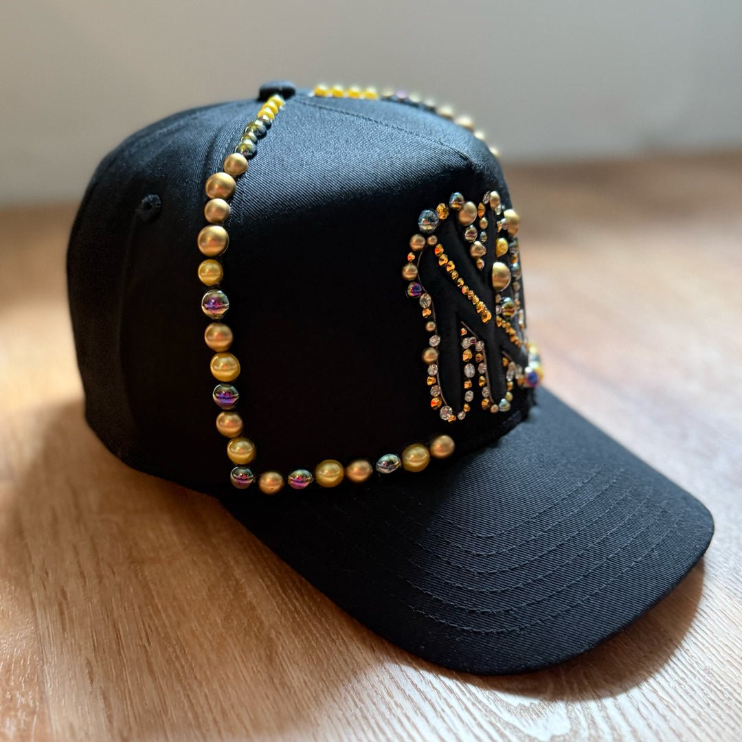side view Black and gold pearl crystal appliqué New York hat with handcrafted embellishments
