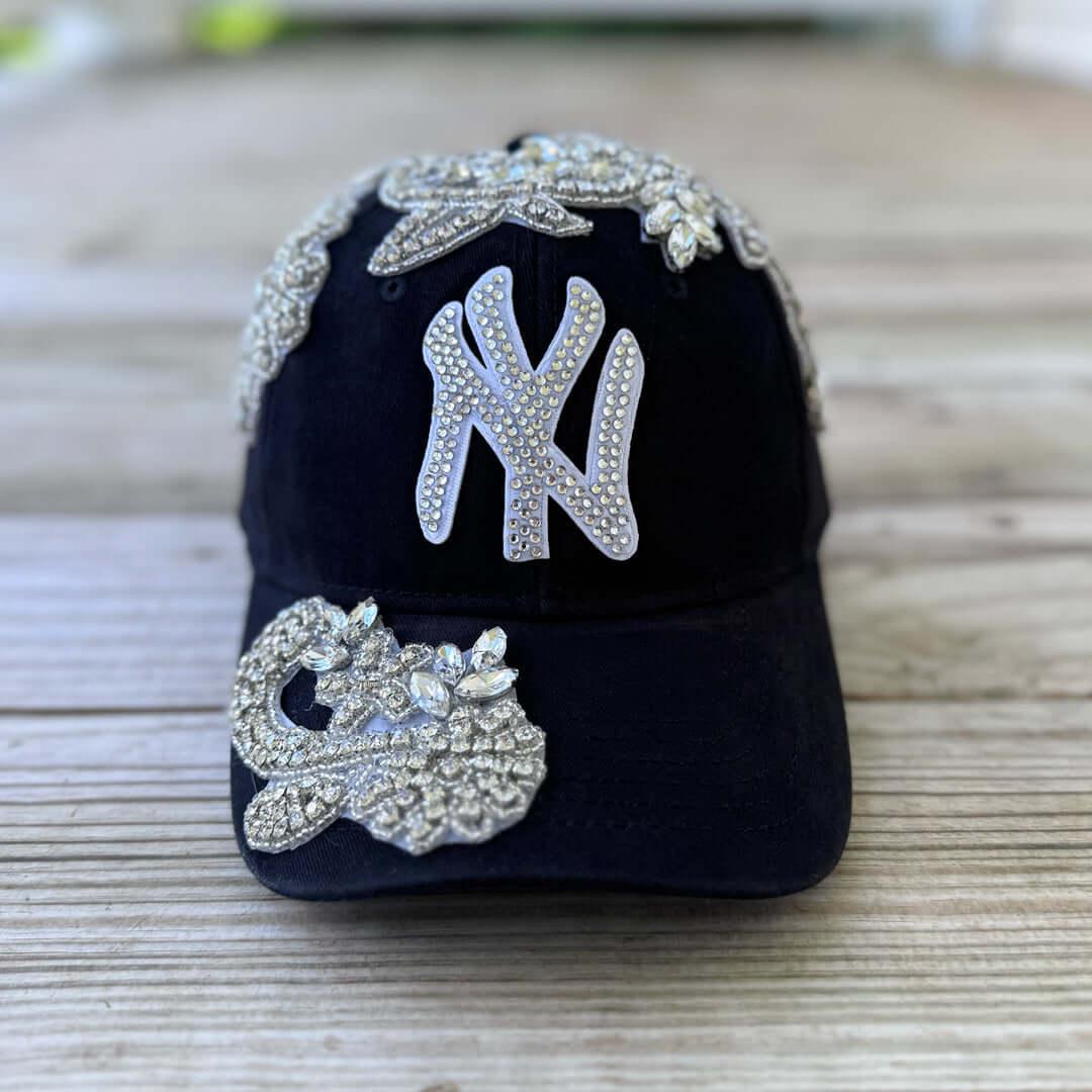 Front view of Silver Crystal Appliqué New York Hat with large statement crystal design