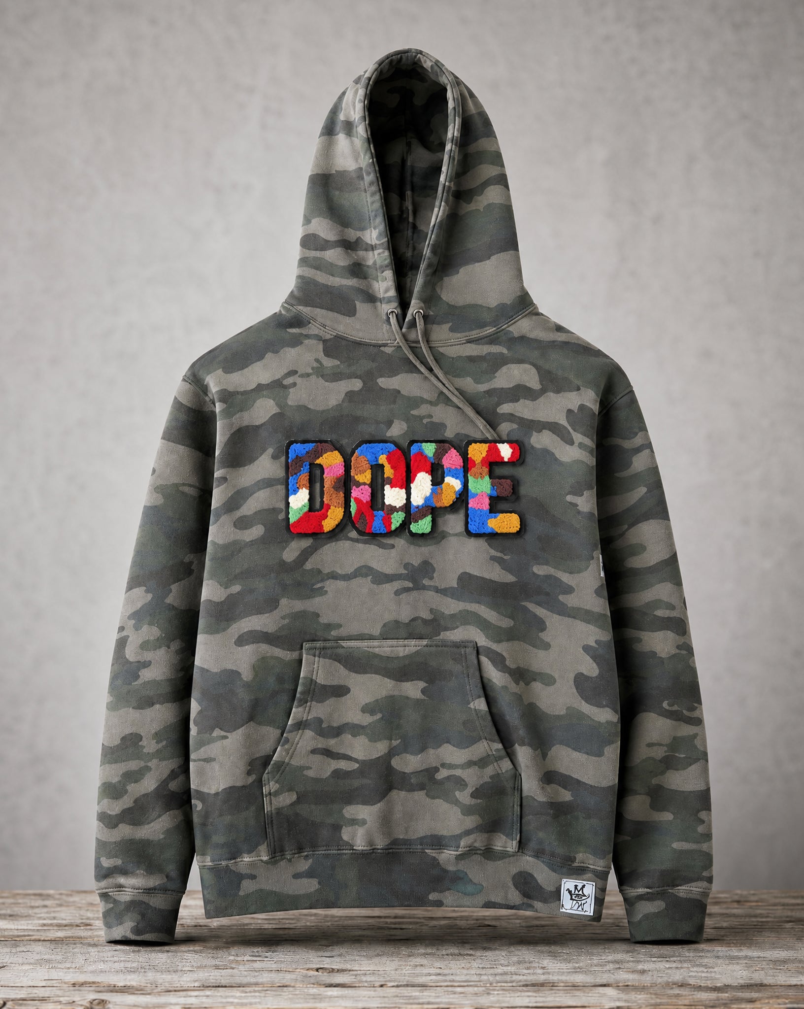 Camouflage hoodie featuring a handcrafted chenille DOPE patch