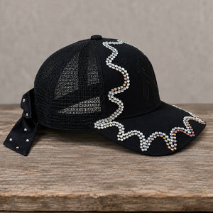 Side view of handcrafted black chameleon crystal appliqué New York hat
