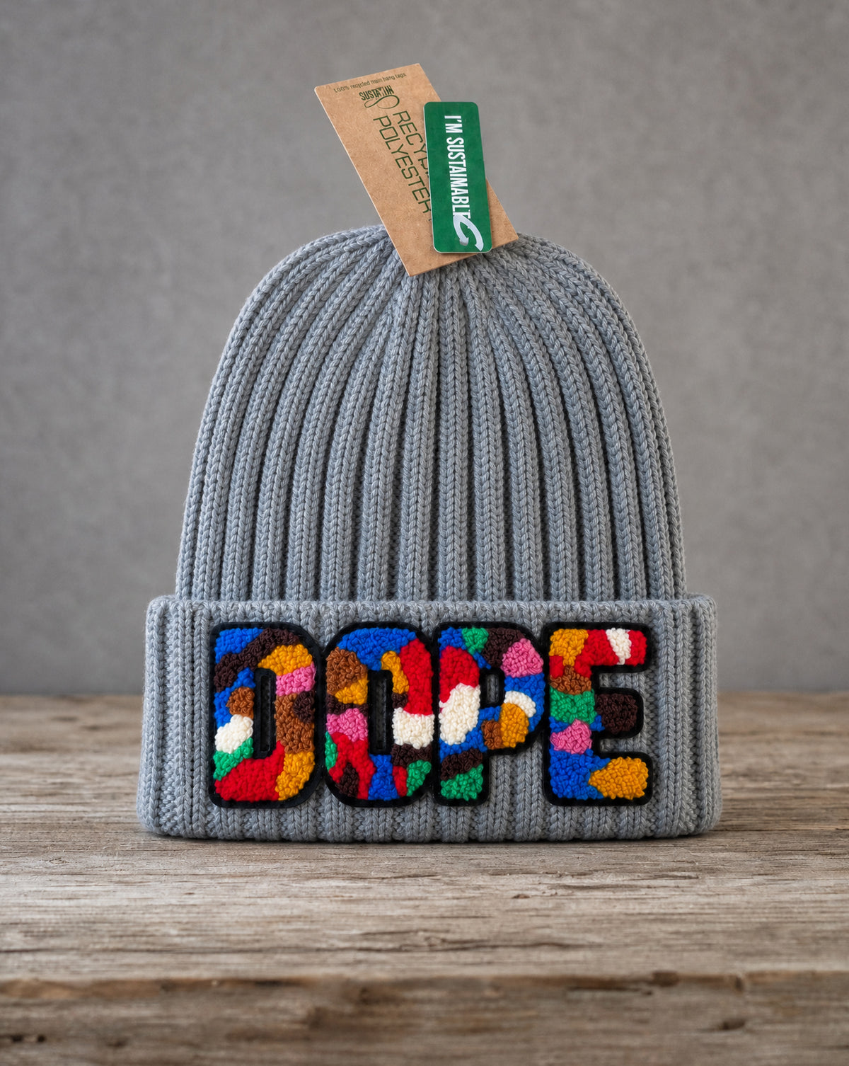 Gray cable knit beanie featuring a handcrafted chenille DOPE patch