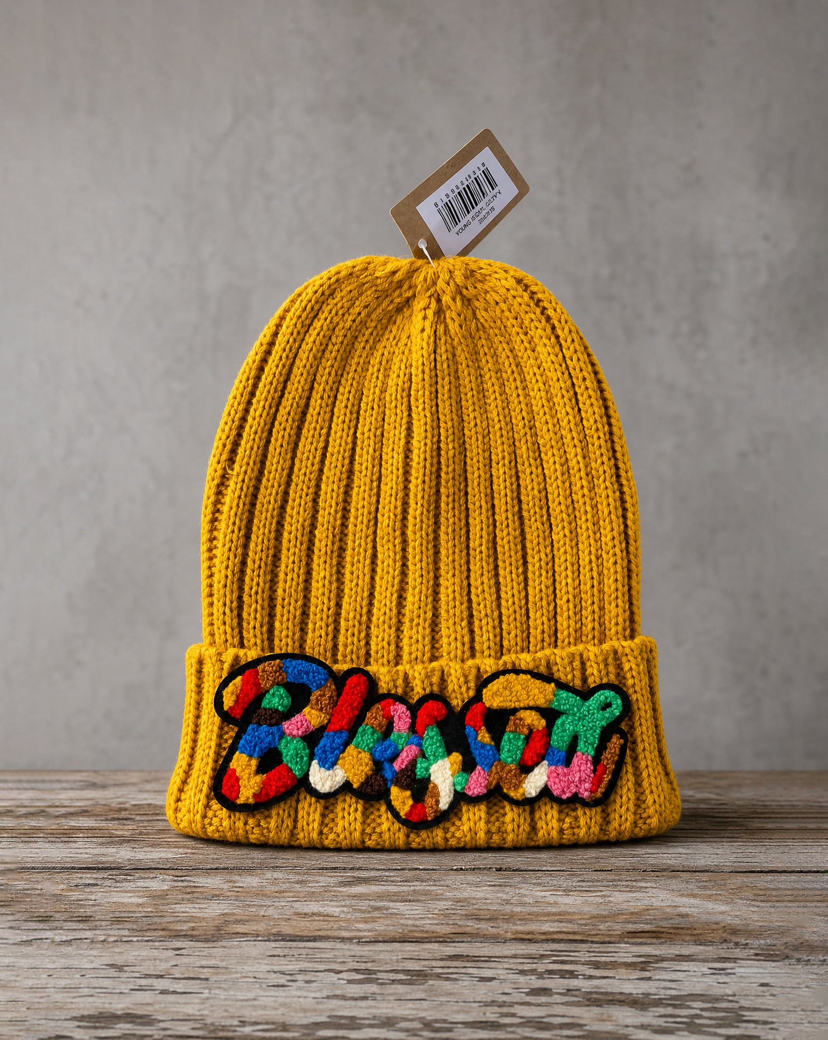 Cable knit beanie featuring a handcrafted chenille Blessed patch