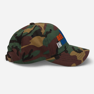 Left view of Believe in NYK camo trucker hat with orange and blue patches - Rebel P Customs