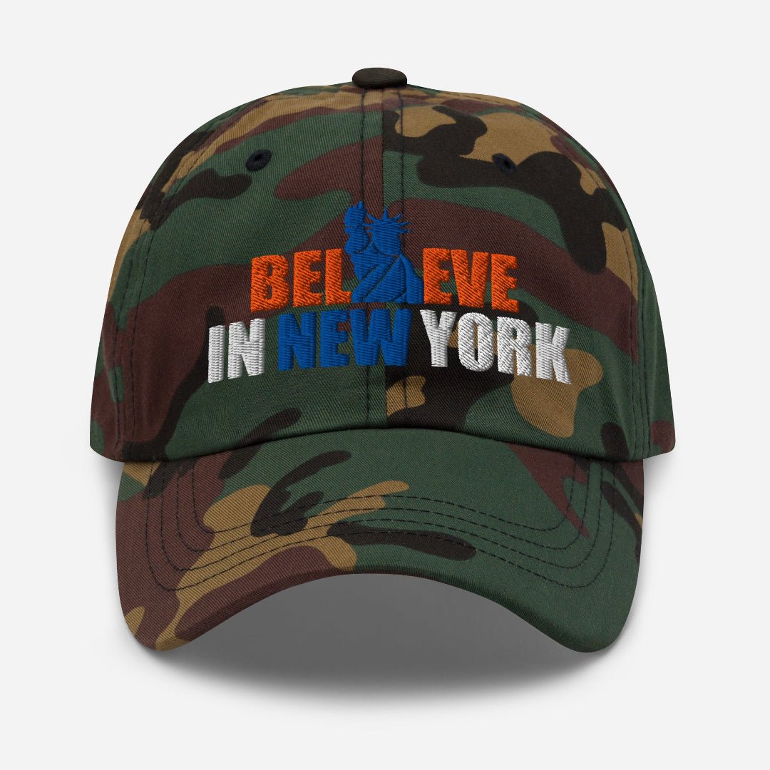 Front view of Believe in NYK camo trucker hat with orange and blue patches - Rebel P Customs